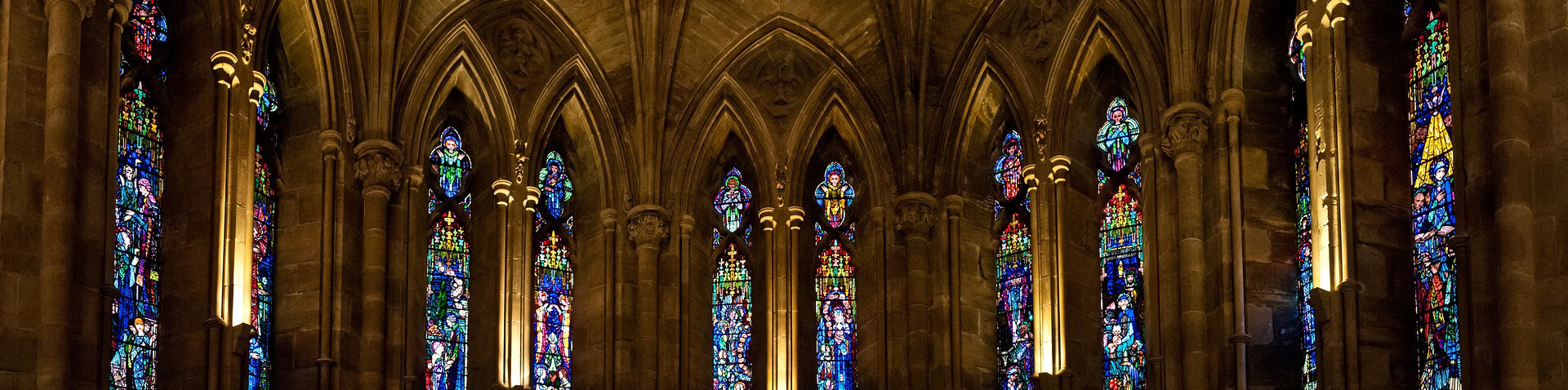 Photo of inside a cathedral with stained glass windows